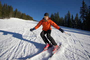 Fototapeta na wymiar female skier carving on an empty slope