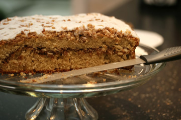 A freshly baked coffee cake on a glass platter