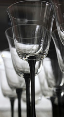 A shelf full of wine glasses on a bar shelf