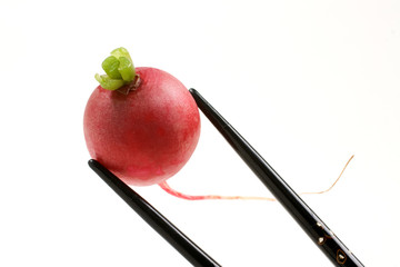 Fresh Radish held with black inlaid chopsticks
