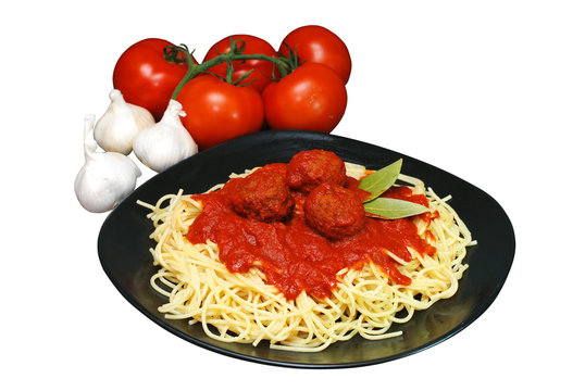Plate of spaghetti and meatballs with tomatoes and garlic.