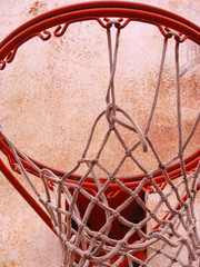 Fototapeta na wymiar A closeup of a playground basketball goal and net.