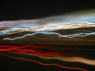 Abstract light trails from cars, signs, and other landmarks.