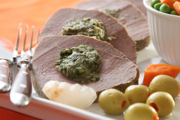 Roast meat with vegetables and olives, close up
