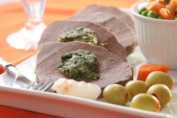 Roast meat with vegetables and olives, close up