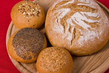 white bread with some buns on the wooden board