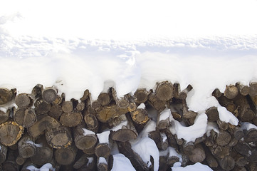woodpile covered with snow 