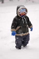 Fototapeta na wymiar Boy in a snowstorm