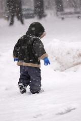 Fototapeta na wymiar Boy in a snowstorm