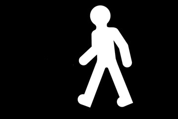 Pedestrian roadsign on a black background, ready to paint.