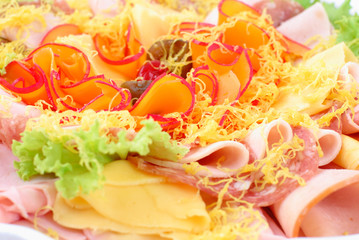 Salami slices and cheese on the cold cut tray in buffet