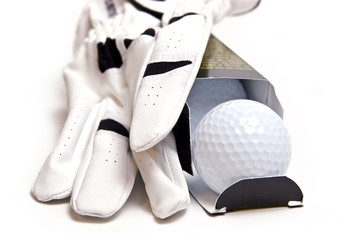 Open box of three premium golf balls.