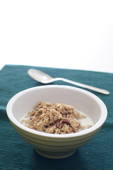 Bowl of crumbly wheat and corn cereal with nutty bits