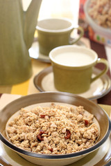 Bowl of crumbly wheat and corn cereal with nutty bits