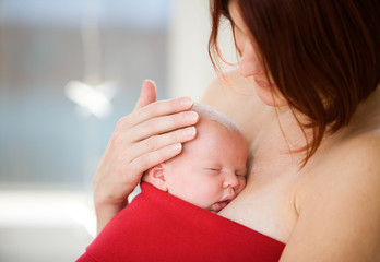 Mother holding sleeping baby girl - 5570584