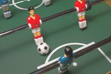 A miniature tabletop foosball arcade type game.