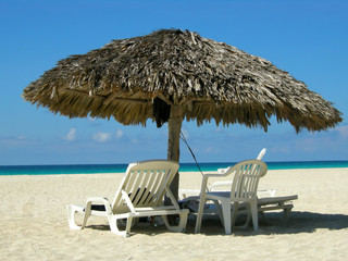 Straw sun shelter and beach chairs at Varadero beach, Cuba