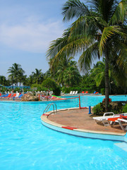 Resort pool with net and loungers at poolside in Cuba