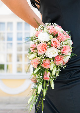 Woman's hand holding beautiful bouquet of roses