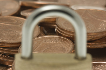 Euro coins viewed through padlock bail.
