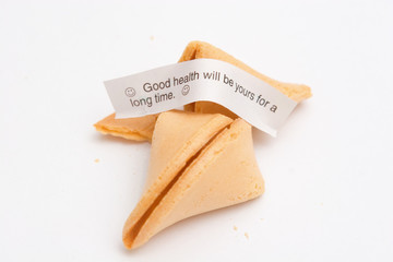 Broken and crumbled fortune cookie, showing a fortune