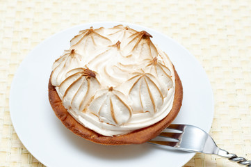 Miniature lemon meringue cake with small silver fork