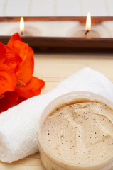 Relaxing spa scene with nourishing and exfoliating scrub