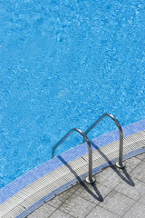 steps into hotel swimming pool summer time 