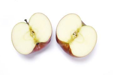 Halves of Fuji apple on white background