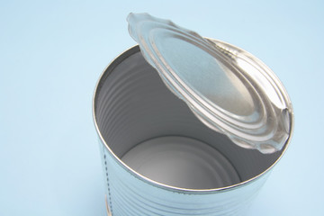 Empty Tin Can on Blue Background