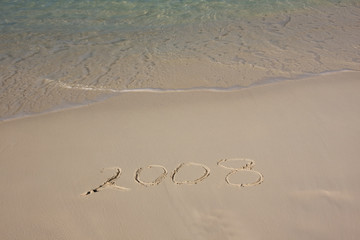 2008 message written in the sand on a tropical beach