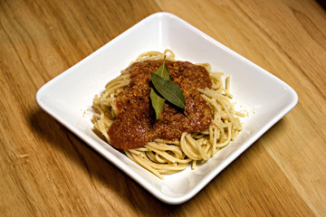 Plate of pasta and sauce on white plate.