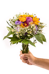 bunch of flowers in the man`s hand