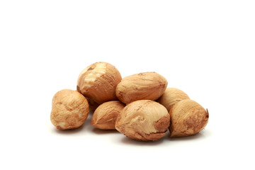 Spilled Hazelnuts on white background