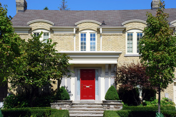 Yellow brick house with red door