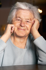 Happy elderly woman looking at the camera