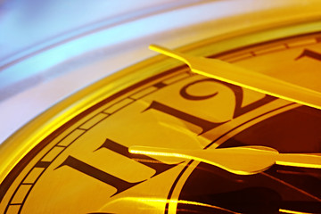 Golden-hued clock, with hands at the eleventh hour.