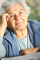 Elderly woman recalling old memories