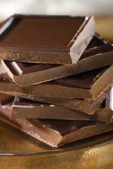 chocolate blocks on golden plate close up shoot