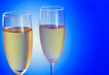 Two Champagne glasses on blue 