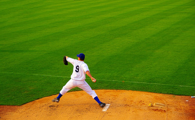Pro baseball  pitcher throwing the ball from the mound