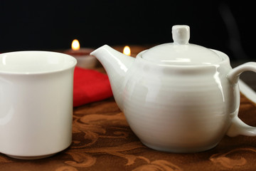 A teacup and mug set on a table for teatime