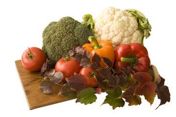 Mediterranean vegetables on a cutting board. Isolated on white.