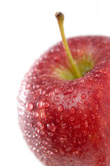 Red apple with water drops on white