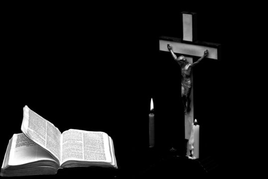  image of a prayer crucifix with  bible open 