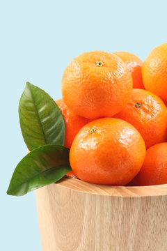 bowl of fresh tangerines isolated on blue