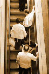 People ascending escalators and stairs..
