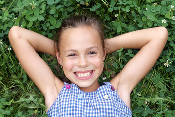 Smiling preteen girl on clover background