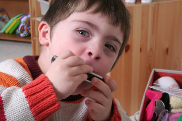 Young boy playing the harmonica
