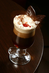 coffee cappuccino with cherry and chocolate on table